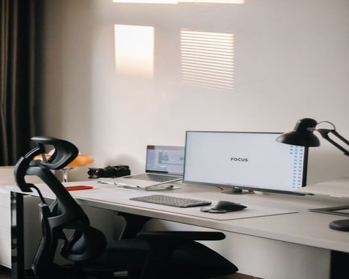 A modern workstation with a focus on an ergonomic chair support setup to encourage good posture